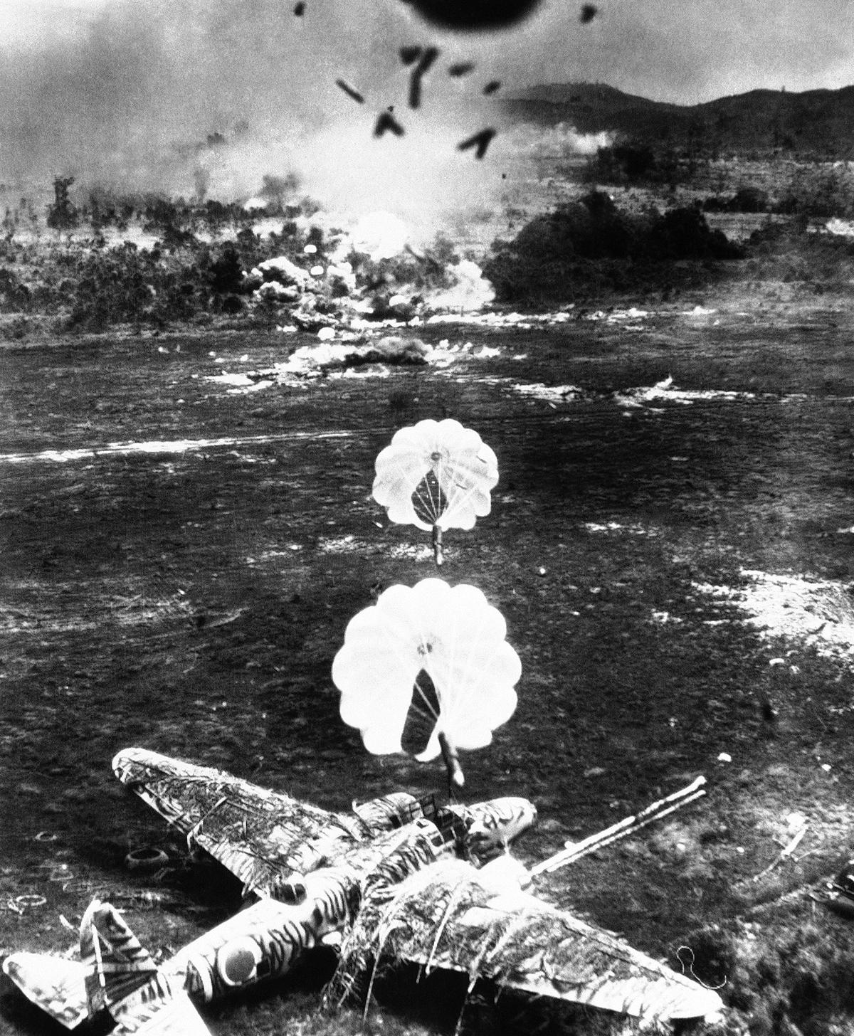 Buru Island , Dutch East Indies,15 Oct 1944, Mitsubishi Ki-21 Sally hit by para-frag bomb